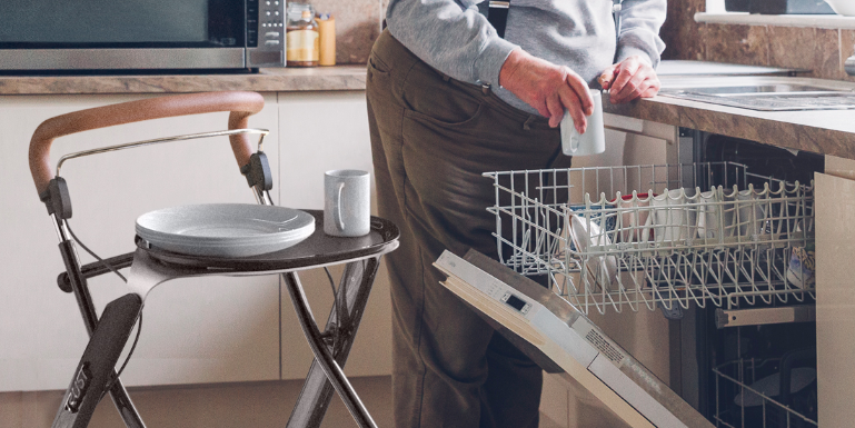 Man by dishwasher with rollator